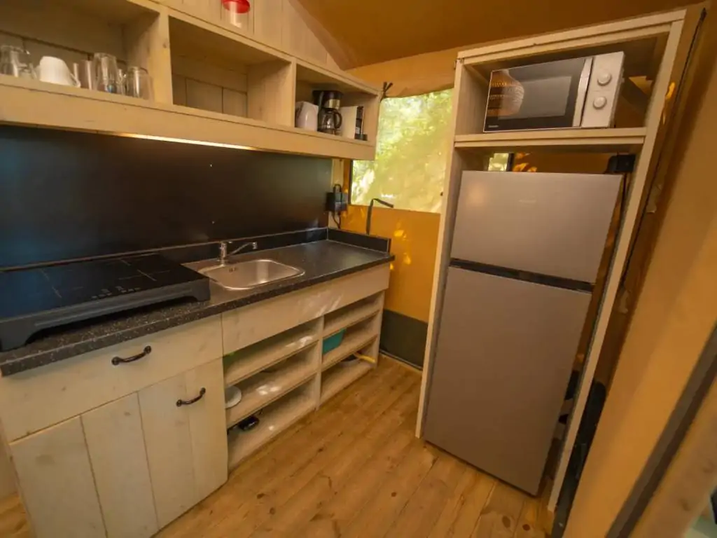 small-orlando-safari-tent-kitchen-with-stove-and-fridge