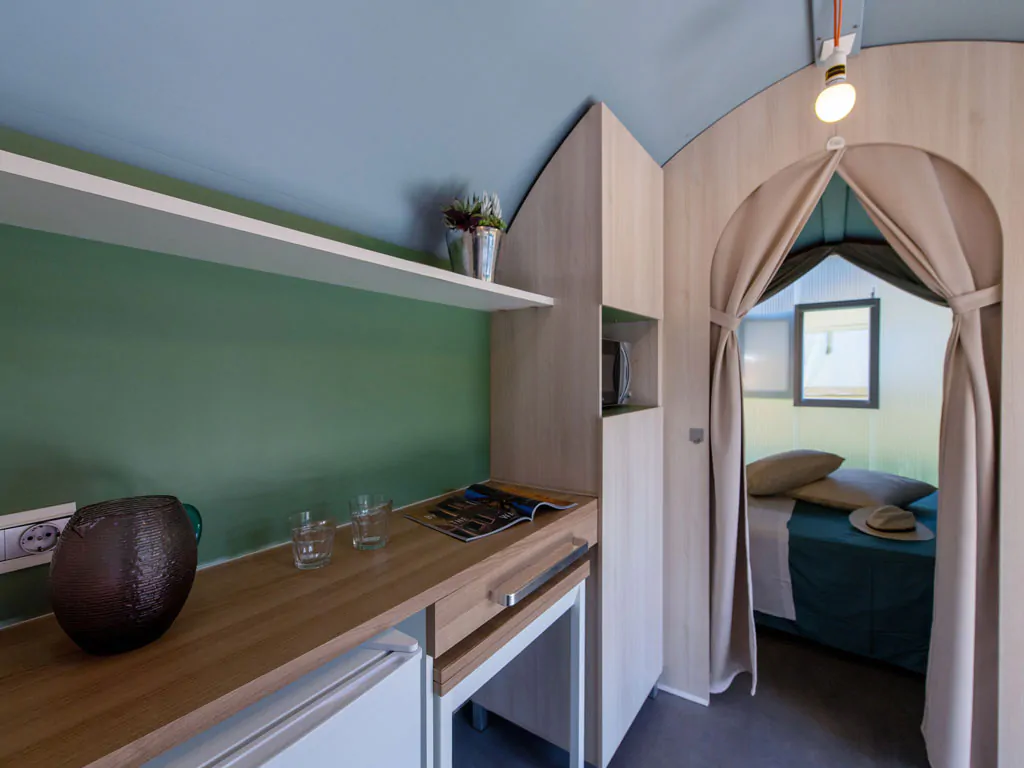 camping-village-punta-navaccia-glamping-tent-coco-tents-interior-kitchen-and-bedroom-view