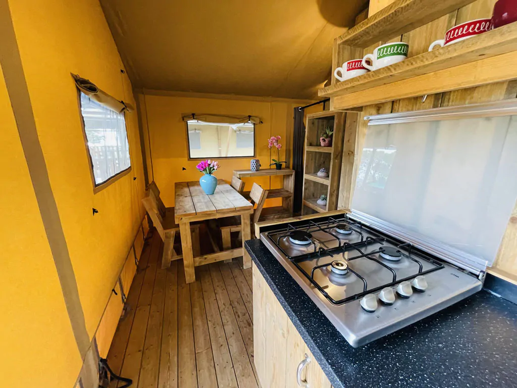 camping-village-punta-navaccia-glamping-tent-safari-lodge-tents-interior-kitchen-and-dining-area-view